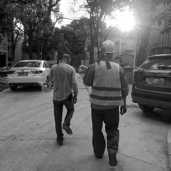 black and white photo of a man and woman in a street