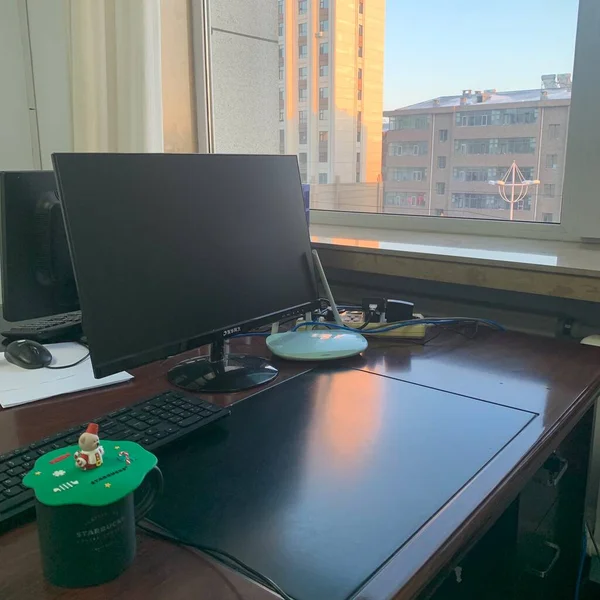 modern office interior with a computer and a glass of coffee.