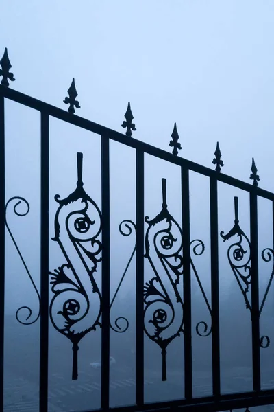 wrought iron fence with a metal railing