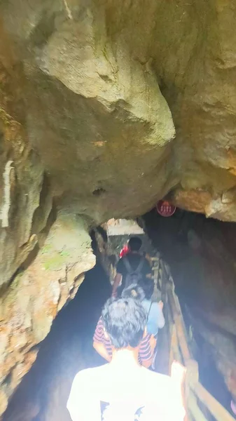 the man is climbing the cave