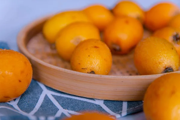 fresh ripe oranges in a bowl on a wooden table