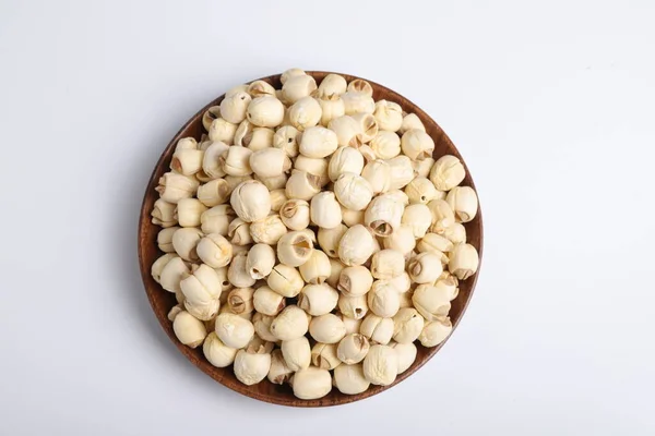 raw chickpeas in a bowl on a white background