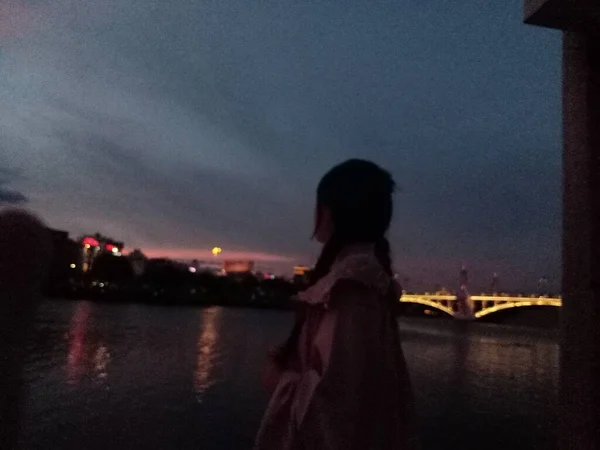 silhouette of a woman in a night city