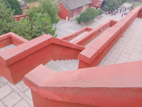 red tile roof with a large layer of a building