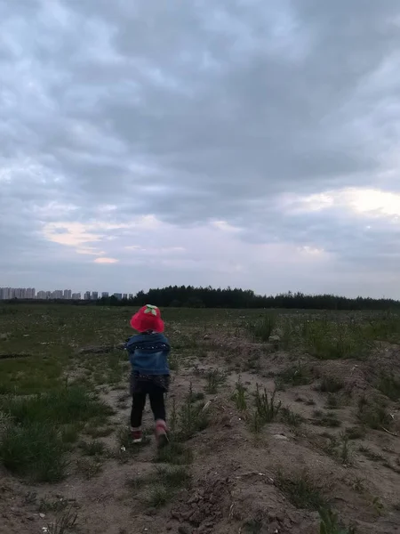 a man in a hat is walking in the field