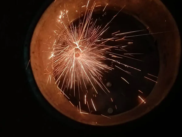 close up of a burning sparkler on a black background