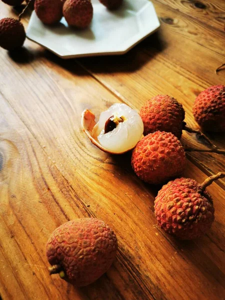 fresh ripe red and white fruits on wooden table