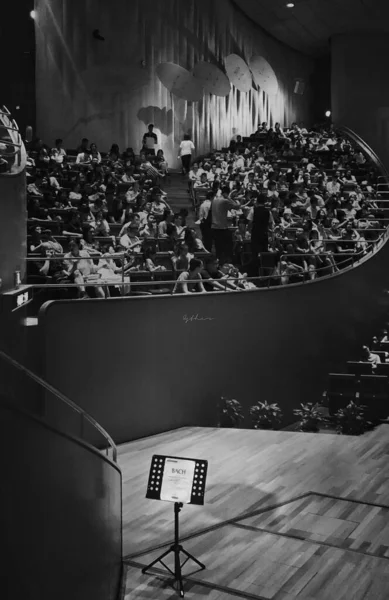 black and white photo of a group of people in the conference hall