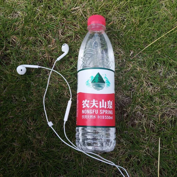 water bottle with a plastic bag on the grass