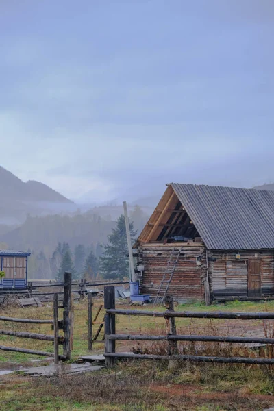 beautiful landscape with a wooden hut and a small house in the mountains