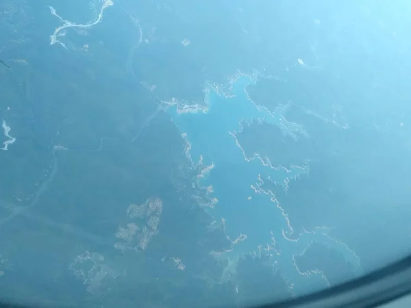 aerial view of the plane window, the sky and the earth.