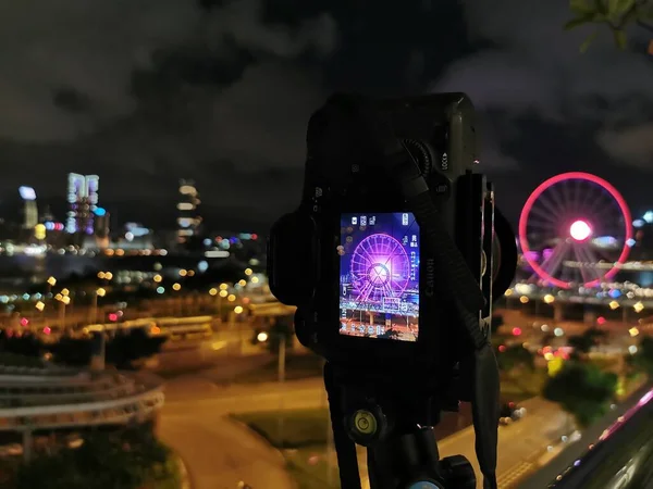 blurred photo of a camera on a background of a city street with a lot of lights