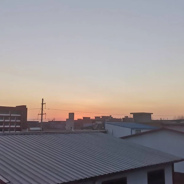 modern roof with red roofs and sunset sky