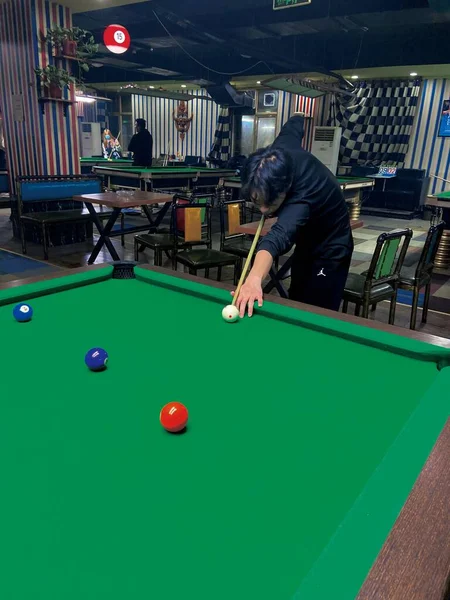 male billiard player with cue in pool