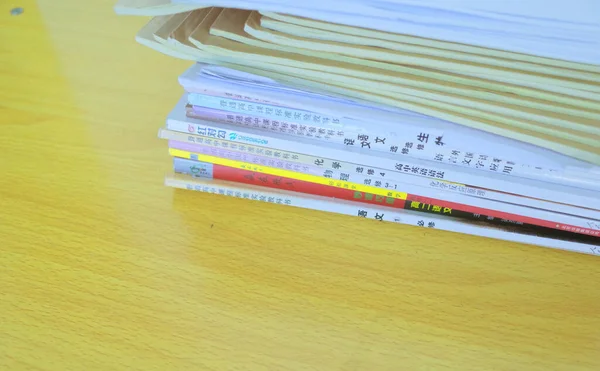 stack of colorful papers on wooden background