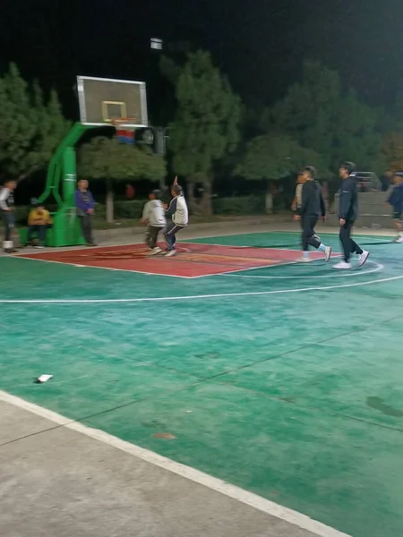 a group of people playing tennis on the playground