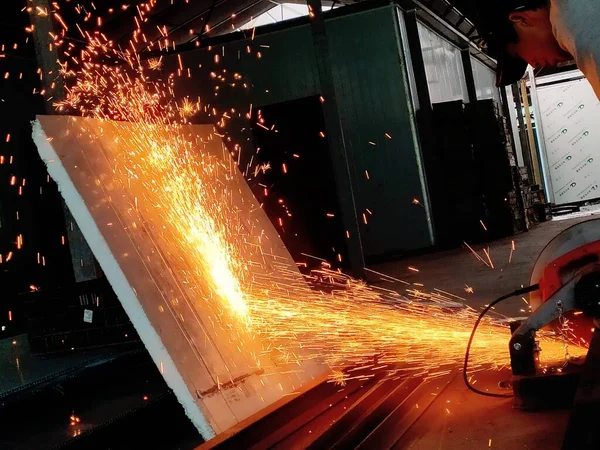 sparks welding metal with a circular saw
