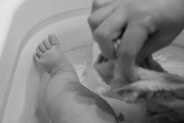woman washing feet in bath