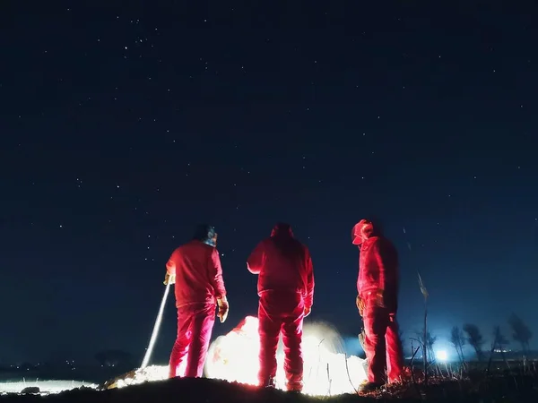 group of people in the night sky