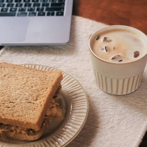 a cup of coffee and a notebook on a wooden table