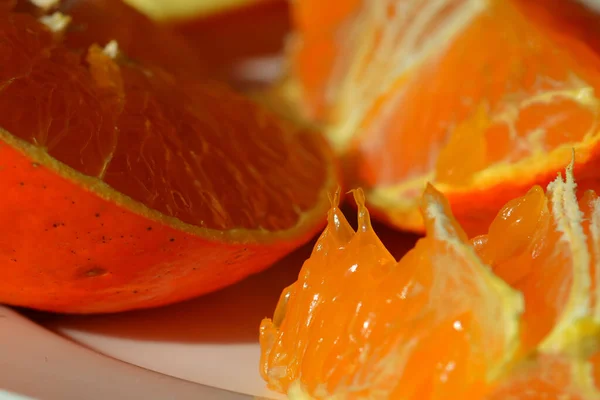 fresh orange and sliced oranges on a white background