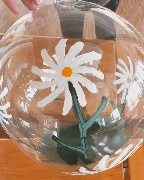 beautiful flower in a glass vase on a wooden table
