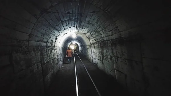 a man in a tunnel with a dark background