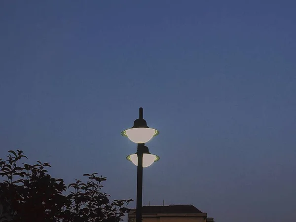 street lamp on the roof of the city