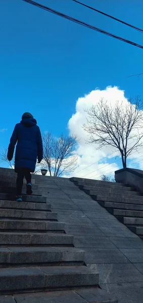 silhouette of a man walking on the stairs of the city