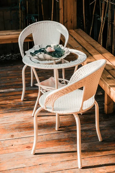 beautiful vintage chair and table with a basket of coffee and a wicker chairs