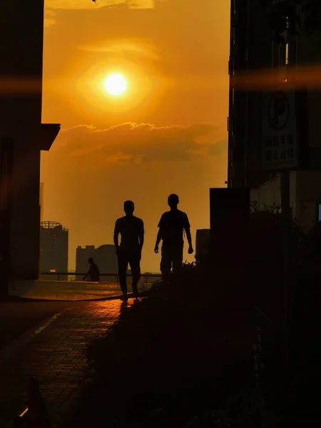 silhouette of a man and woman in the city