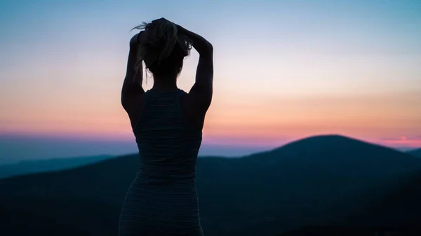 silhouette of a woman in a dress on the beach