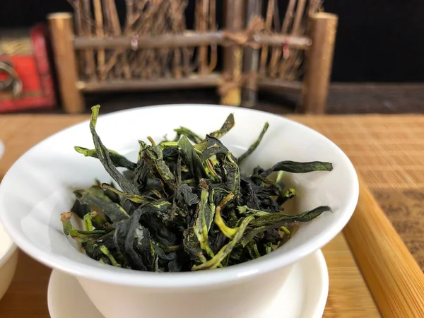 dried green tea leaves in a bowl