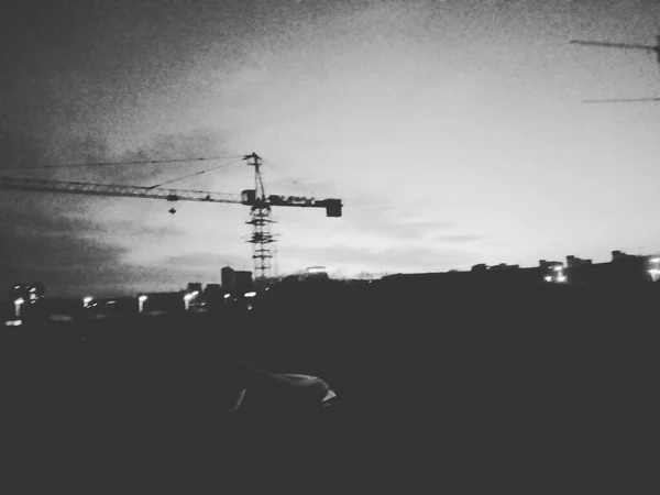 silhouette of a construction building on the background of the city