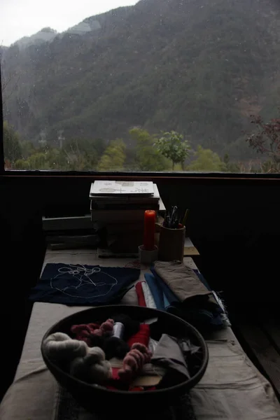 a view of a window with a cup of tea and a tent