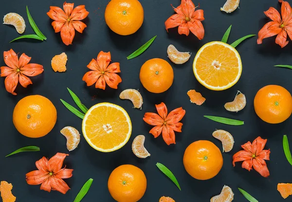 top view of fresh orange citrus fruits on black background.