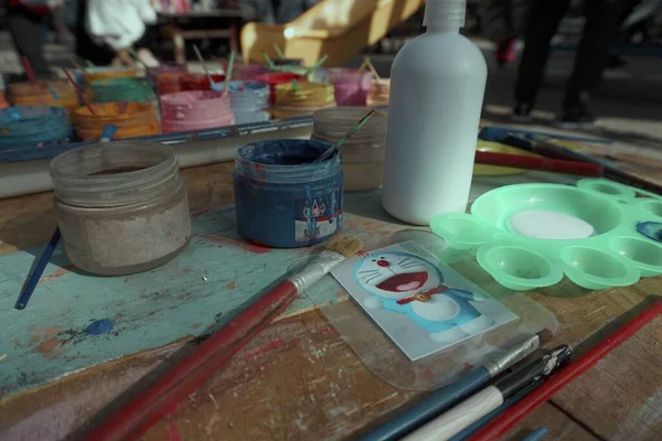 artist paints palette in the workshop