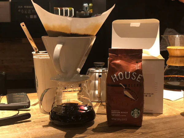 coffee shop, food and drink concept-close up of a glass jar with a lid and a bottle