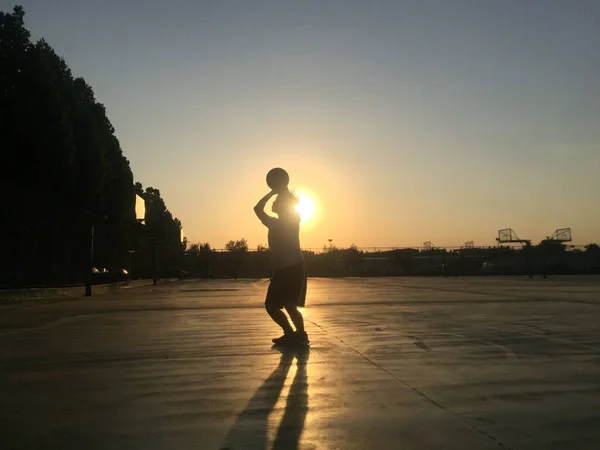 silhouette of a man running on the beach