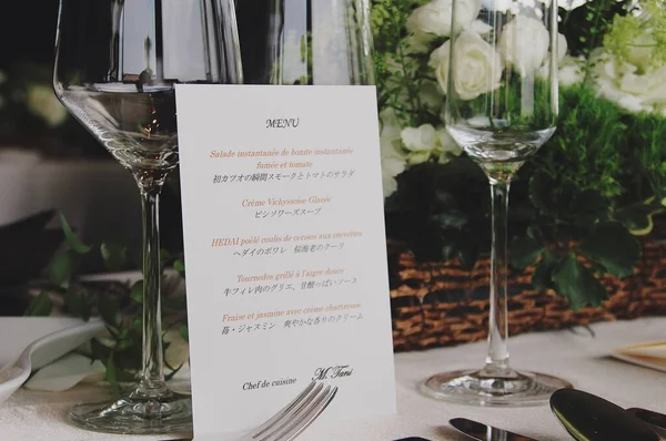 wedding table setting with white wine glasses and flowers