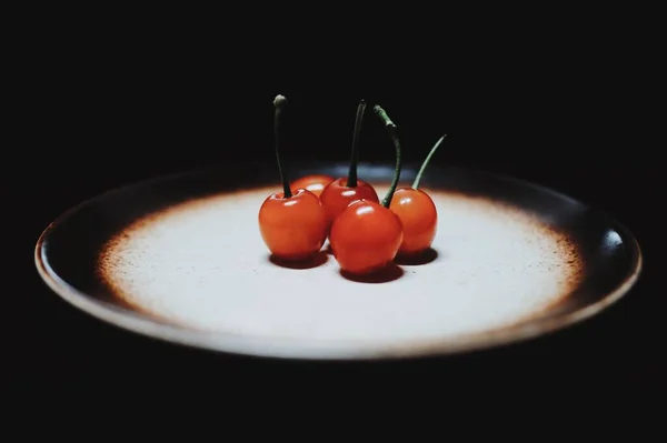 cherry berries on a black background