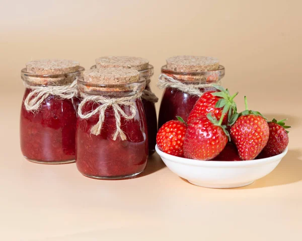 strawberry jam in a jar on a white background