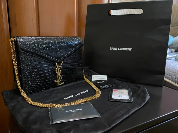 black leather wallet with a bag and a purse