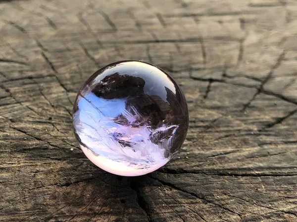 earth globe with a small ball on a wooden background