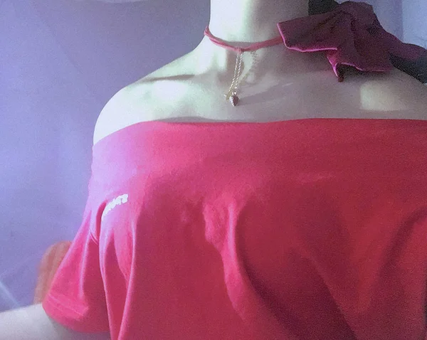 mannequin in a dress with a red ribbon