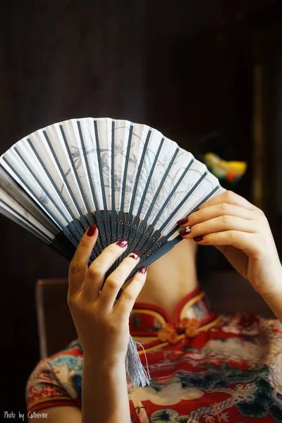 woman holding a fan in her hands
