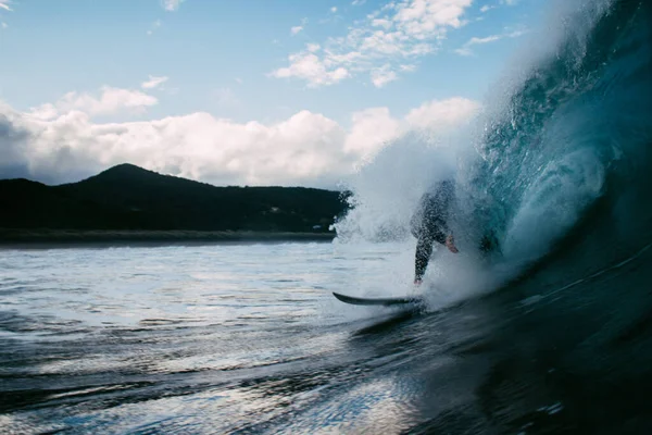 surfer riding a wave on the beach