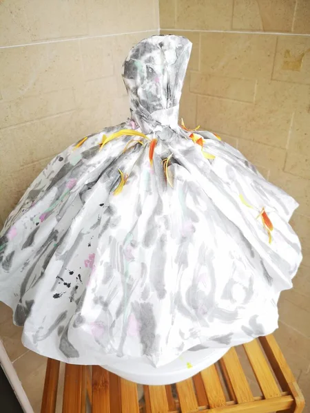 white wedding dress with a bag of flowers