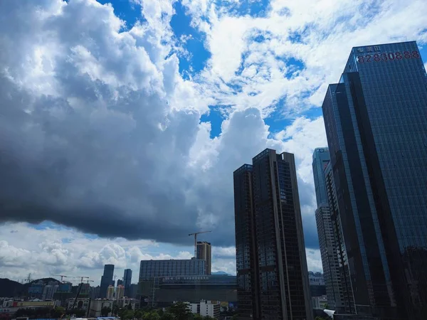 modern city buildings, skyscrapers and clouds