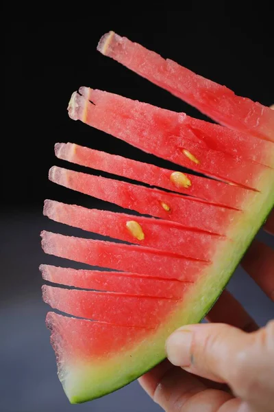 sliced watermelon on a black background